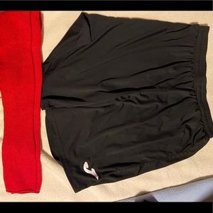 Black soccer shorts and red soccer socks